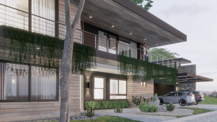 Modern two-story house with wooden siding, large windows, and a spacious balcony. Two people are standing on the balcony, overlooking the yard. There are two cars parked in the driveway, and the yard has a tree, plants, and rocks for landscaping.