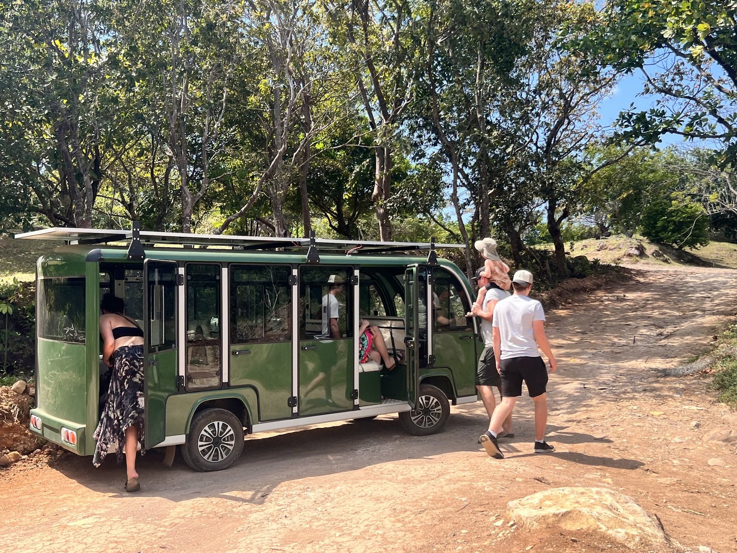 Electric shuttle at Veritas Village with visitors boarding