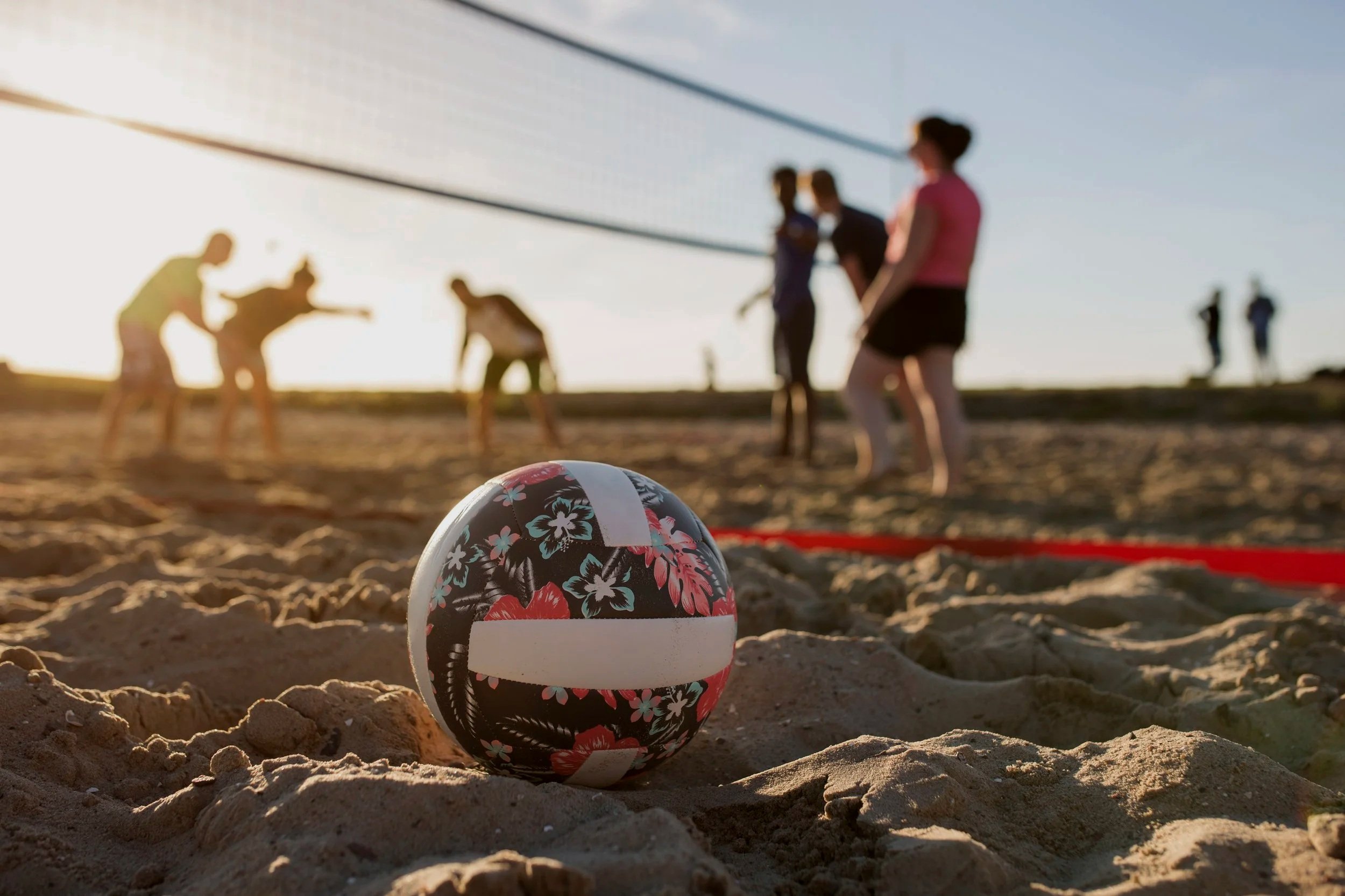 Friends playing volleyball on the sand
