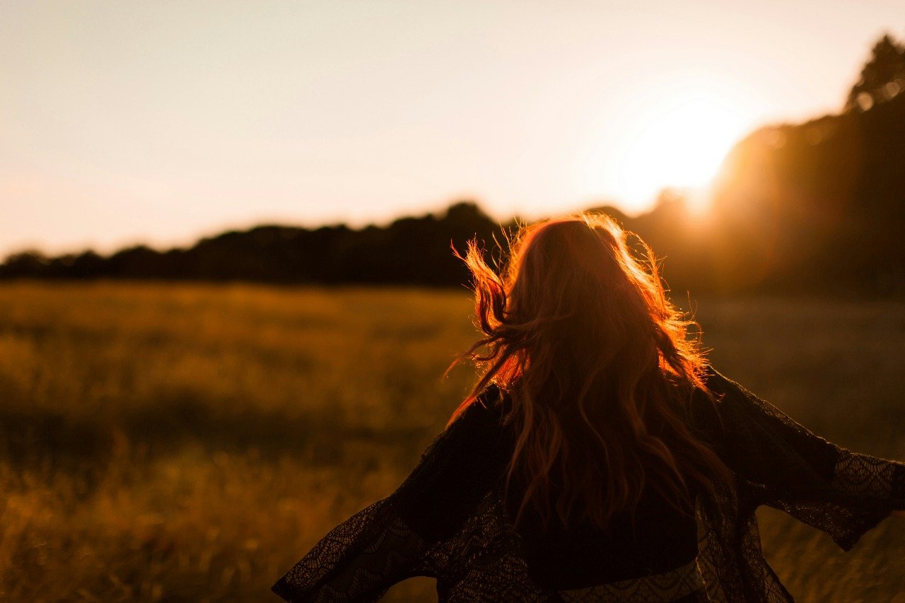 Woman at sunset in a golden field